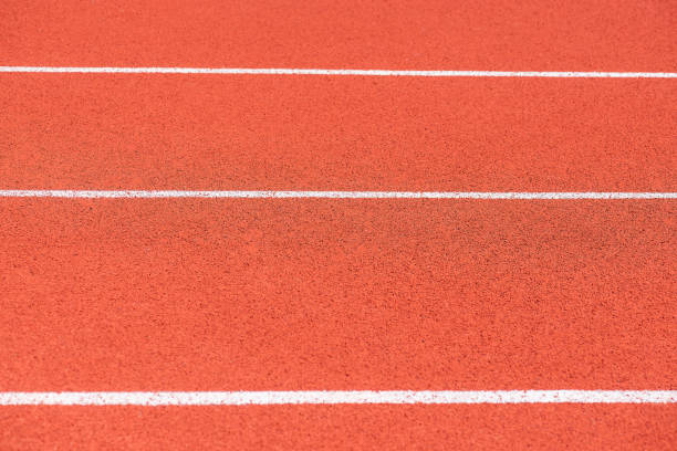 istock Close up of Running track pattern background in stadium. 1055291278
