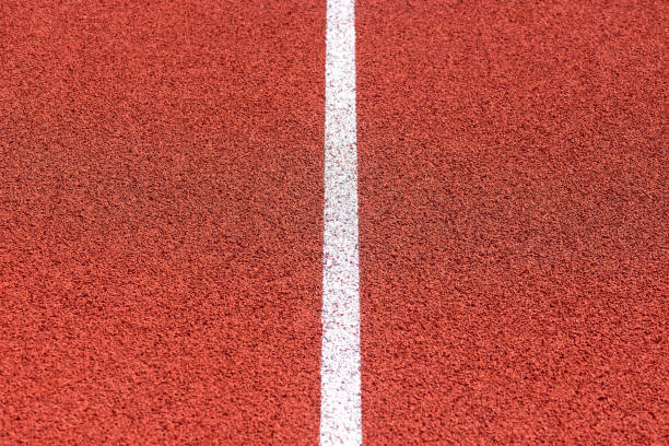 istock Close up of Running track pattern background in stadium. 1055291288