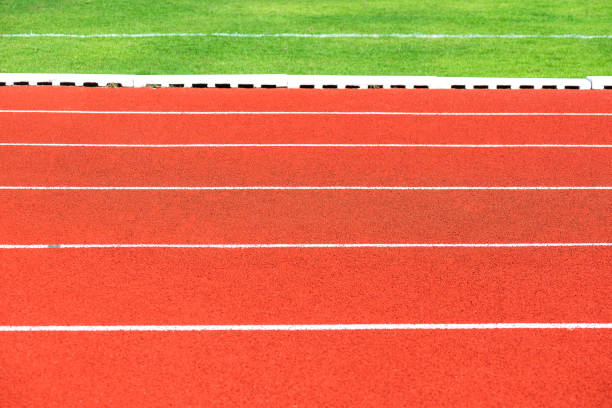 istock Close up of Running track pattern background in stadium. 1055291314