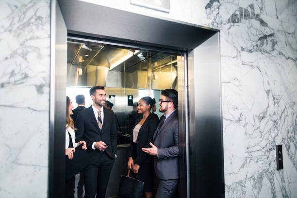 Young group of latin millennial executives in elevator stock photo