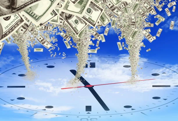 istock conceptual money storm of tornado on clock face 1055295554