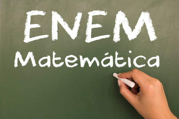 istock Female hand writing with chalk on empty green chalkboard. (translation portuguese: ENEM - National High School Exam Brazil - mathematics) 1055304200