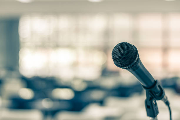 istock Microphone voice speaker in seminar classroom, lecture hall or conference meeting in educational business event for host, teacher, or coaching mentor 1055309506