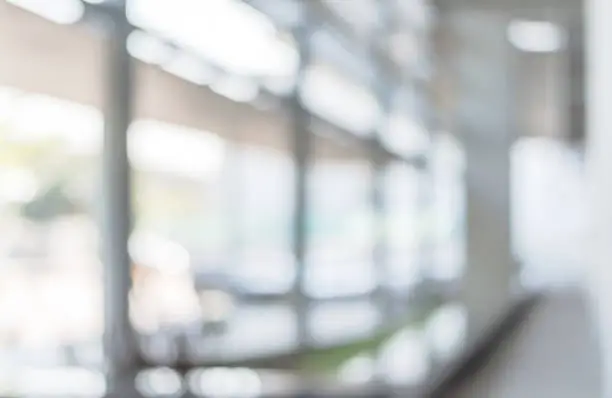 Photo of Blur background interior view looking out toward to empty office lobby and entrance doors and glass curtain wall