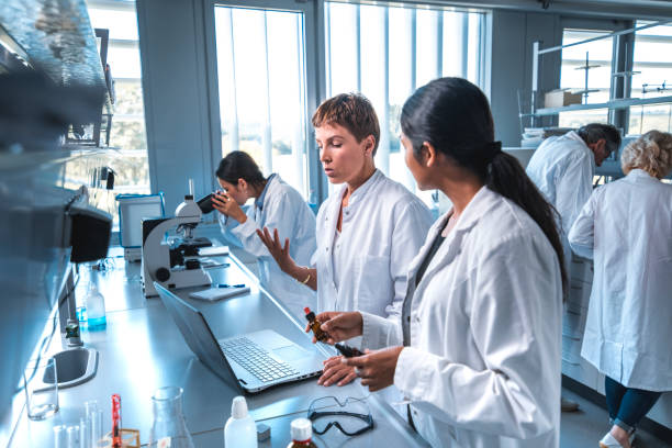 istock Researcher discussing with colleague in laboratory 1055312620