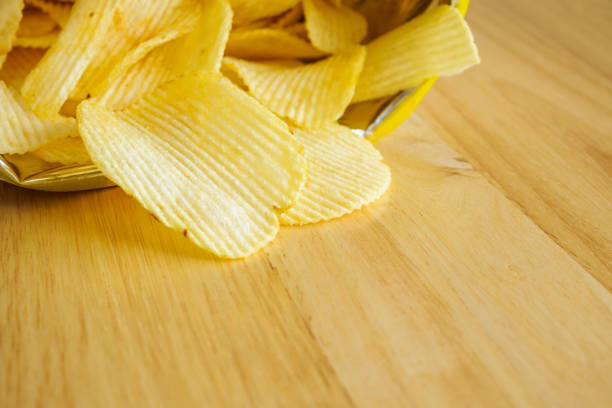 istock potato chips open bag on wood table 1055313738