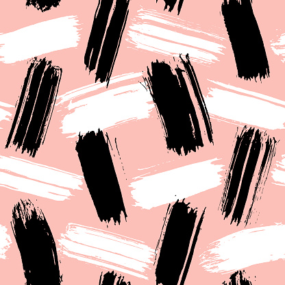 Seamless pattern with black and white hand-drawn ink brush stripes and strokes isolated on peach-colored background. Rough shapes vector backdrop. Doodle style abstract grunge texture.