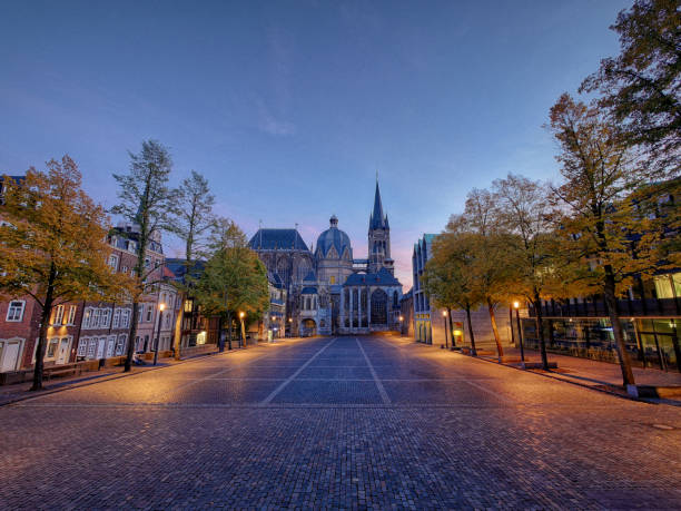Aachen, Germany - February 23, 2025: Pedestrians in front of Aachen Cathedral in winter.
