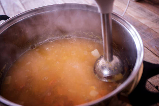 istock Home cooking, pumpkin soup preparing, blending 1055339138