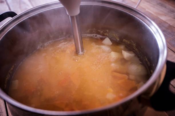 istock Home cooking, pumpkin soup preparing, blending 1055339152