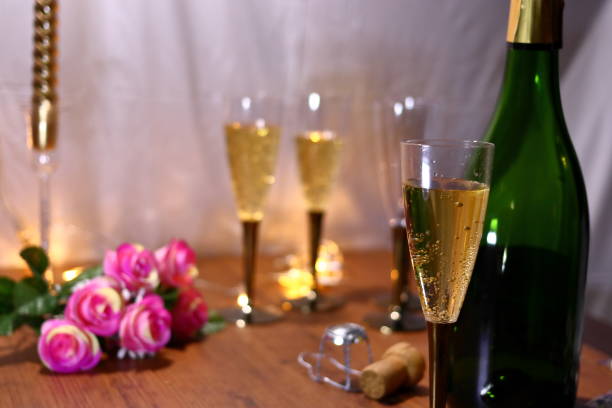 istock Champagne and bottle, roses and Christmas tree 1055344950