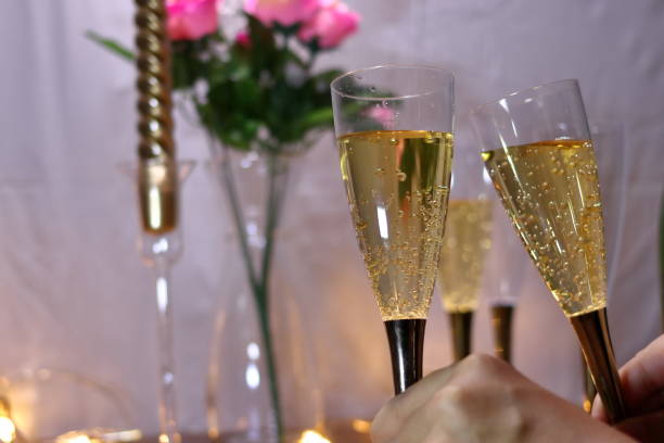 istock A hand toasting with a champagne glass 1055344994