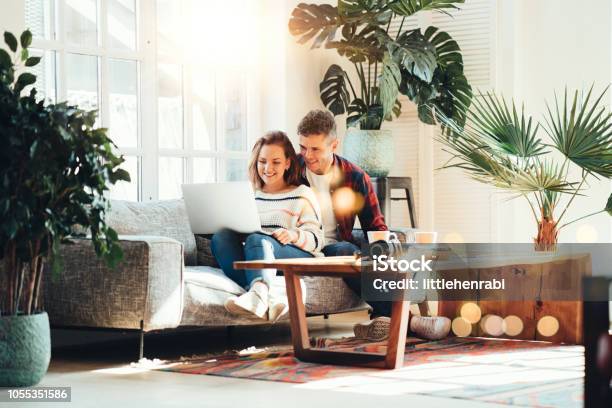 Family Relationship Happy Couple At Home On The Couch Stock Photo - Download Image Now