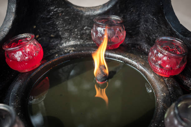istock Burning candle in oil in a buddhist temple 1055359720