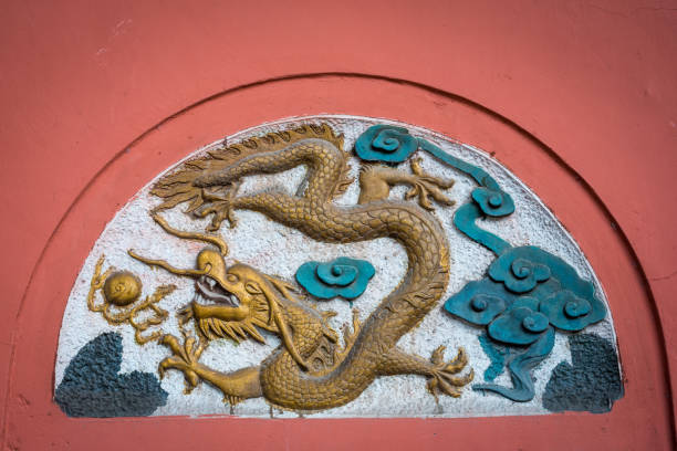 istock Dragon fresco bas-relief on a red wall in China 1055359728