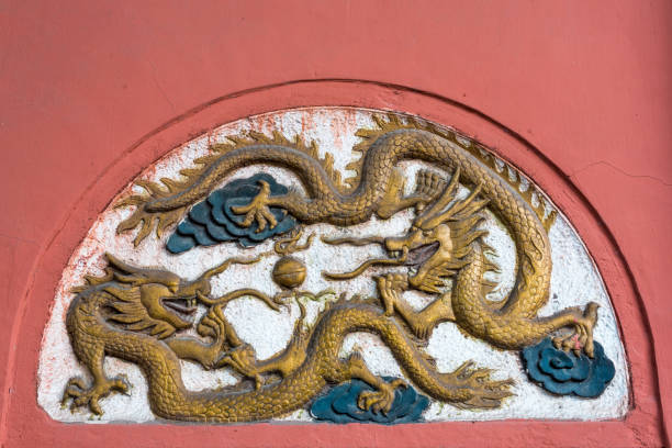 istock Dragon fresco bas-relief on a red wall in China 1055359818