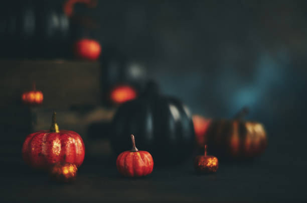 istock Glittery Halloween Background with Black and Orange Pumpkins 1055362138