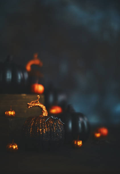istock Glittery Halloween Background with Black and Orange Pumpkins 1055362140