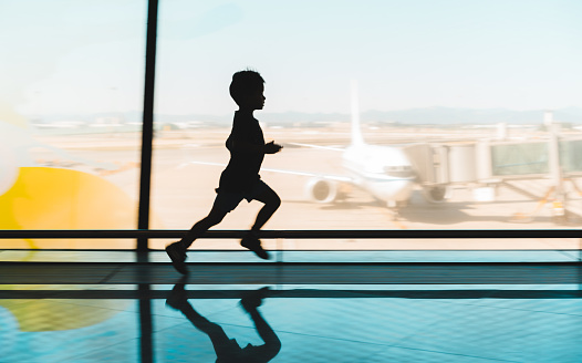 Kid at airport terminal Running.