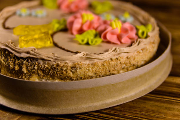 istock Kiev cake with cream on wooden table 1055370978
