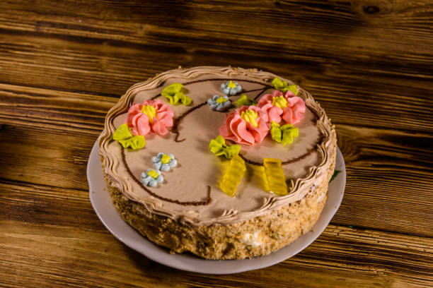 istock Kiev cake with cream on wooden table 1055370990