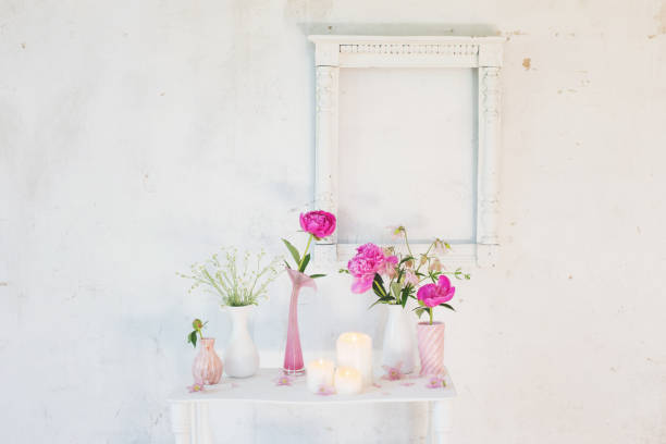 istock flowers in vases and candles on white background 1055379984
