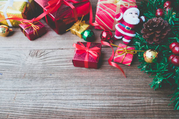 istock Christmas background with decorations and gift boxes on wooden board.vintage tone 1055381608
