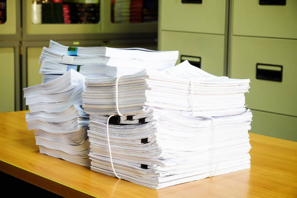 istock Pile of unfinished documents on office desk, Stack of business paper 1055381710