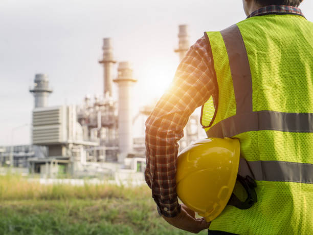 istock engineering man with white safety helmet standing in front of oil refinery building structure in heavy petrochemical industry 1055384232