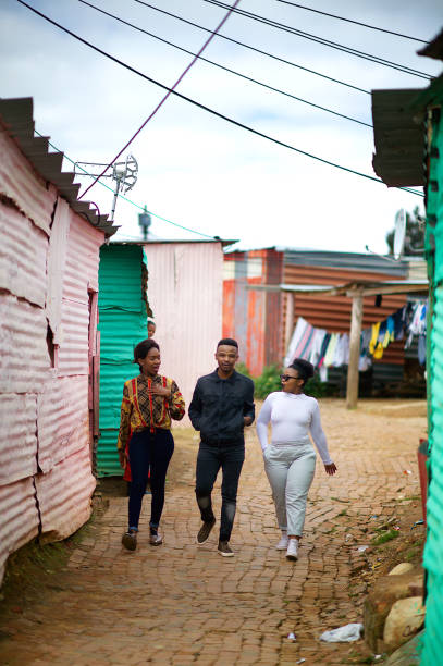 istock Three Friends Walking together in Township Talking 1055385840