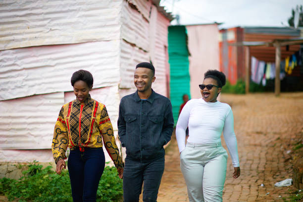 istock Three Friends Walking together in Township Smiling 1055385876
