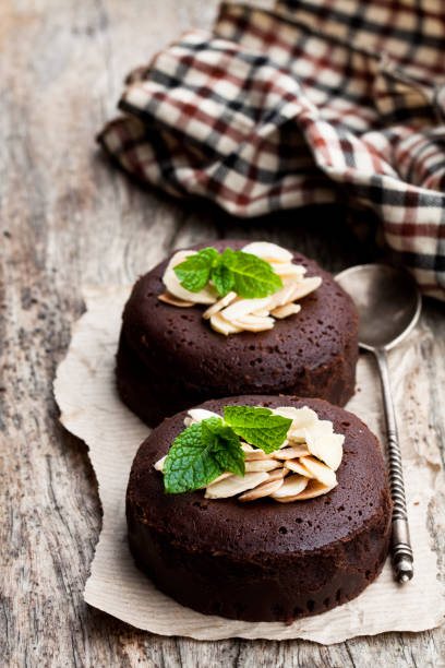 istock Chocolate fondant with almonds on wooden table 1055387464