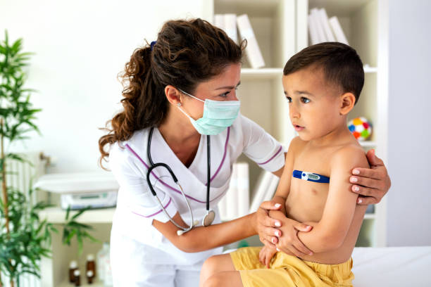 istock Doctor checking body temperature of young boy 1055387634