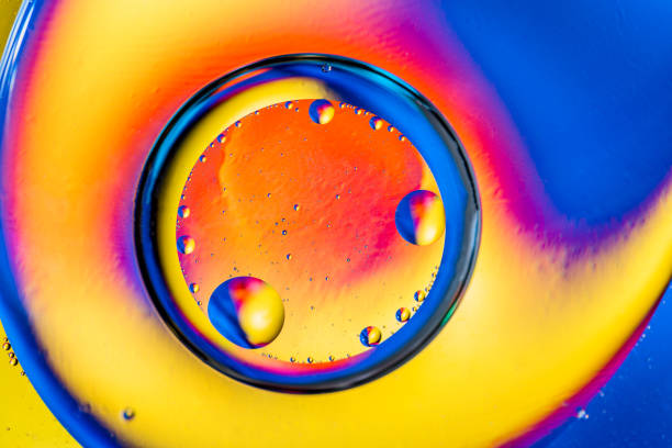 istock Abstract background with colorful gradient colors. Oil drops in water abstract psychedelic pattern image. Blue orange yellow colored abstract pattern. 1055392410