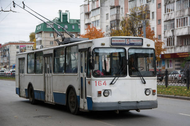 Yoshkar-Ola. Russia - October 2018: Old white with a blue stripe a trolleybus in the center of a large city carries passengers