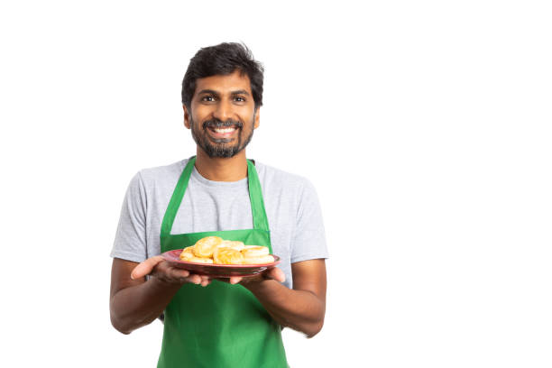 istock Indian man presenting donuts with happy expresion 1055394866