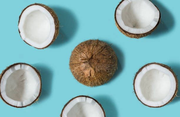 istock Top view of coconut isolated on blue background Summer concept. Flat lay. 1055400202