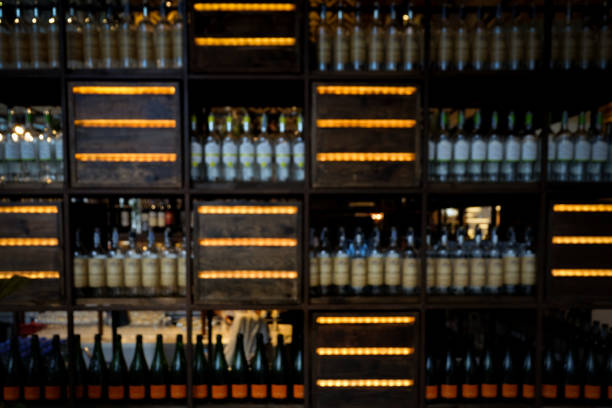 istock blur alcohol drink bottle on bar counter in the dark night background. 1055401986