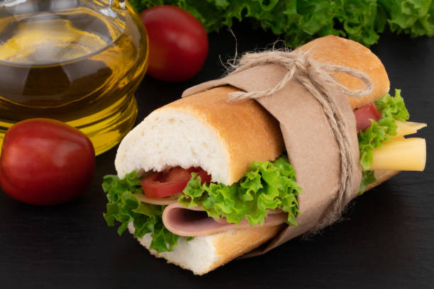 istock sandwich with with ham, cheese, tomatoes, lettuce on over stone 1055404844