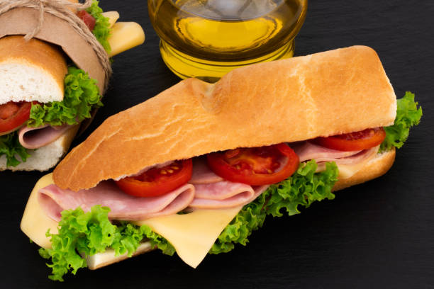 istock sandwich with with ham, cheese, tomatoes, lettuce on over stone 1055404888