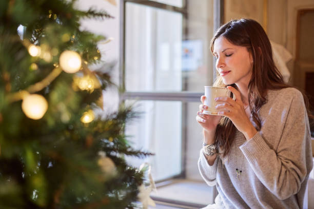 istock Happy woman contemplating her christmas tree. 1055405988