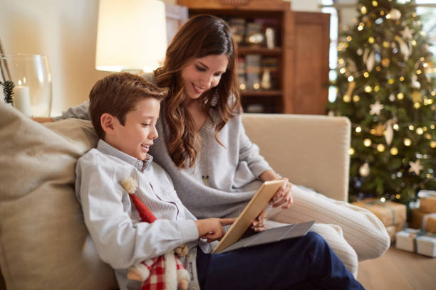 istock Celebrating Christmas, happy people at home. 1055406038