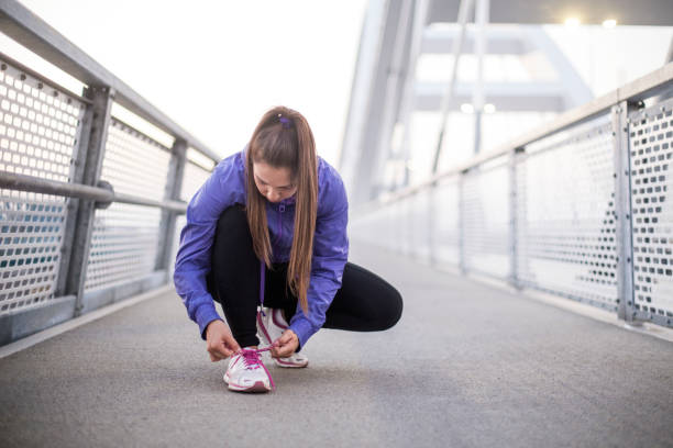 istock Woman tying her sholaces 1055408730