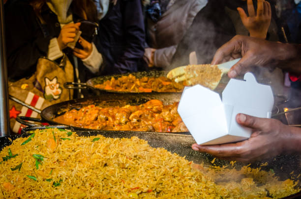 istock Hand serve food in a box rice and eastern meat 1055411836