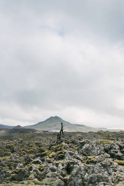 istock Man standing on lava field in Iceland 1055421248
