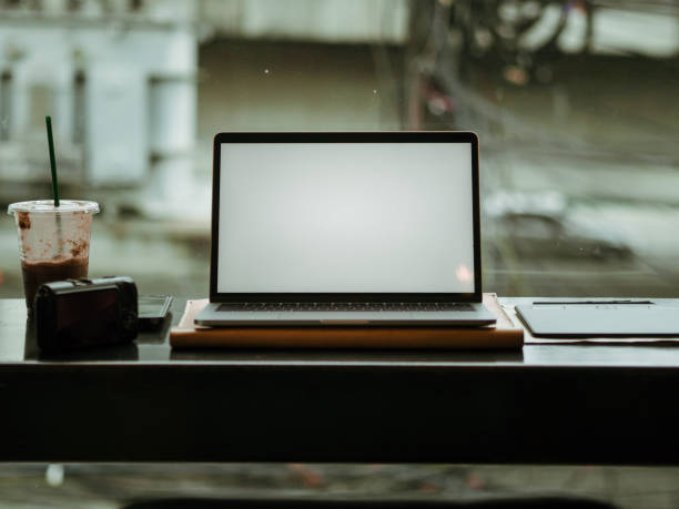 istock Empty screen laptop with camera and ice coffee in the cafe. 1055424226