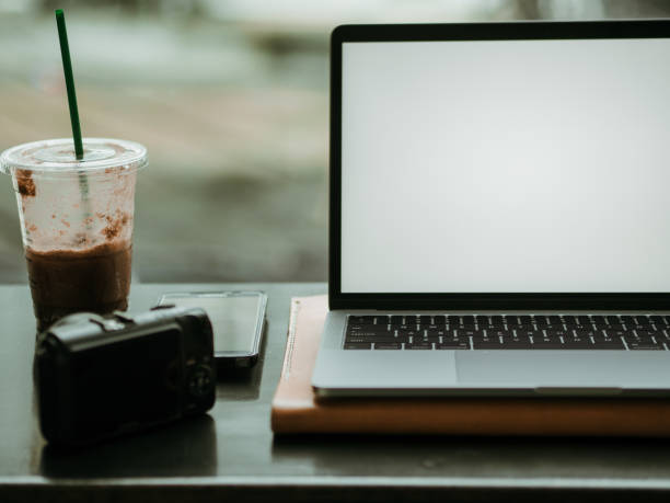 istock Empty screen laptop with camera and ice coffee in the cafe. 1055424322