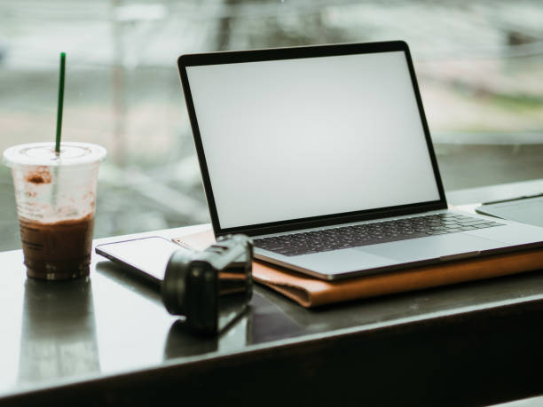 istock Empty screen laptop with camera and ice coffee in the cafe. 1055424496