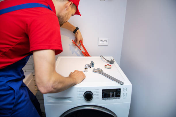 istock plumber installing washing machine in domestic bathroom 1055429556