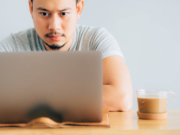 istock Serious face man work on his laptop. 1055430624